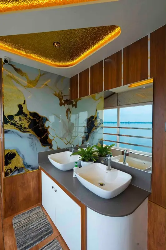 Marble bathroom with twin basins and lake view