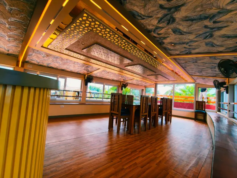 Open upper-deck dining hall of an Alleppey day cruise houseboat